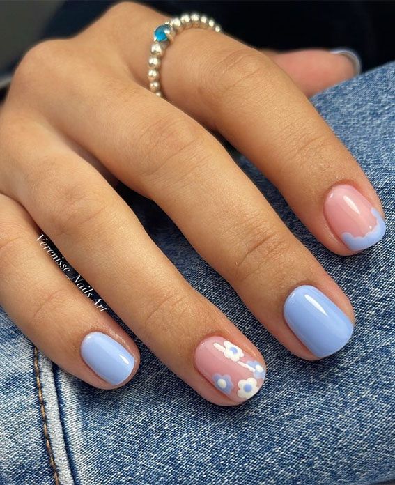 Playful Pastel Manicure with Floral Accents for a Whimsical Spring Vibe.