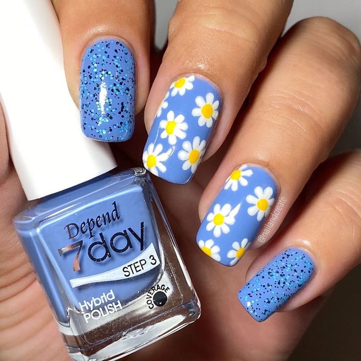 Playful Spring-Inspired Vibrant Blue Nail Design with Glitter and Daisies.