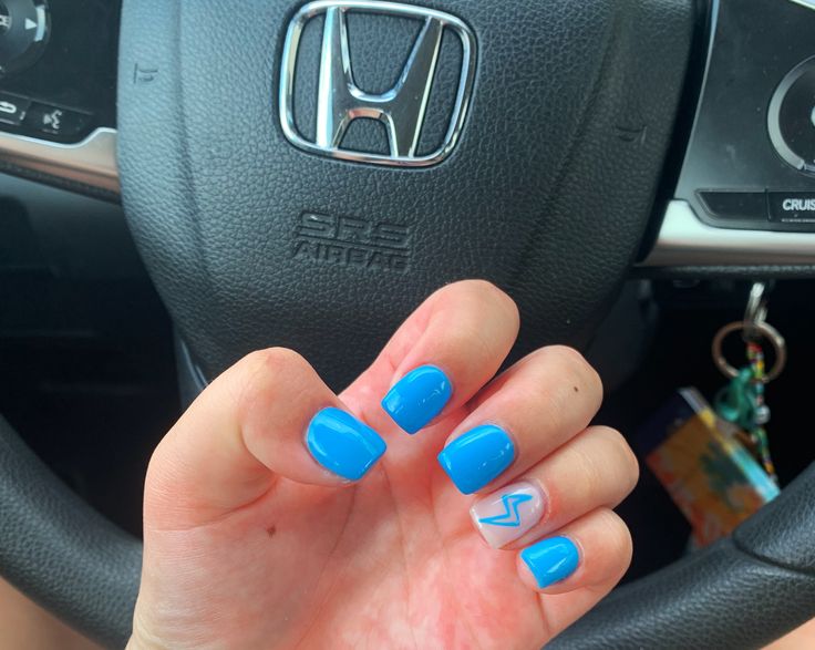 Vibrant Blue Nail Design with Glossy Finish and Bold Zigzag Accent.