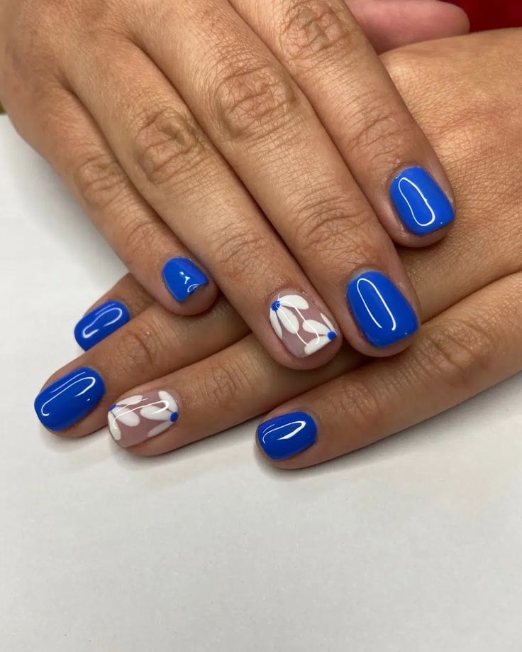 Elegant Vibrant Blue Nail Design with Glossy Finish and White Floral Accents