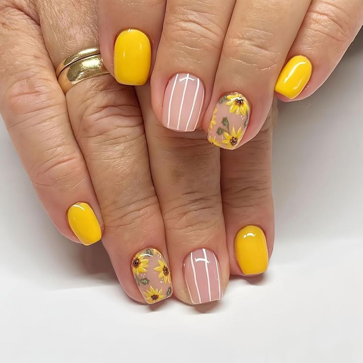 Cheerful Nail Art: Bright Yellow and Pastel Floral Designs for a Playful Look.