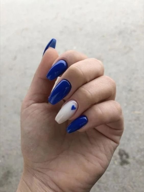 Chic Deep Blue Nail Design with Playful Heart Accent.