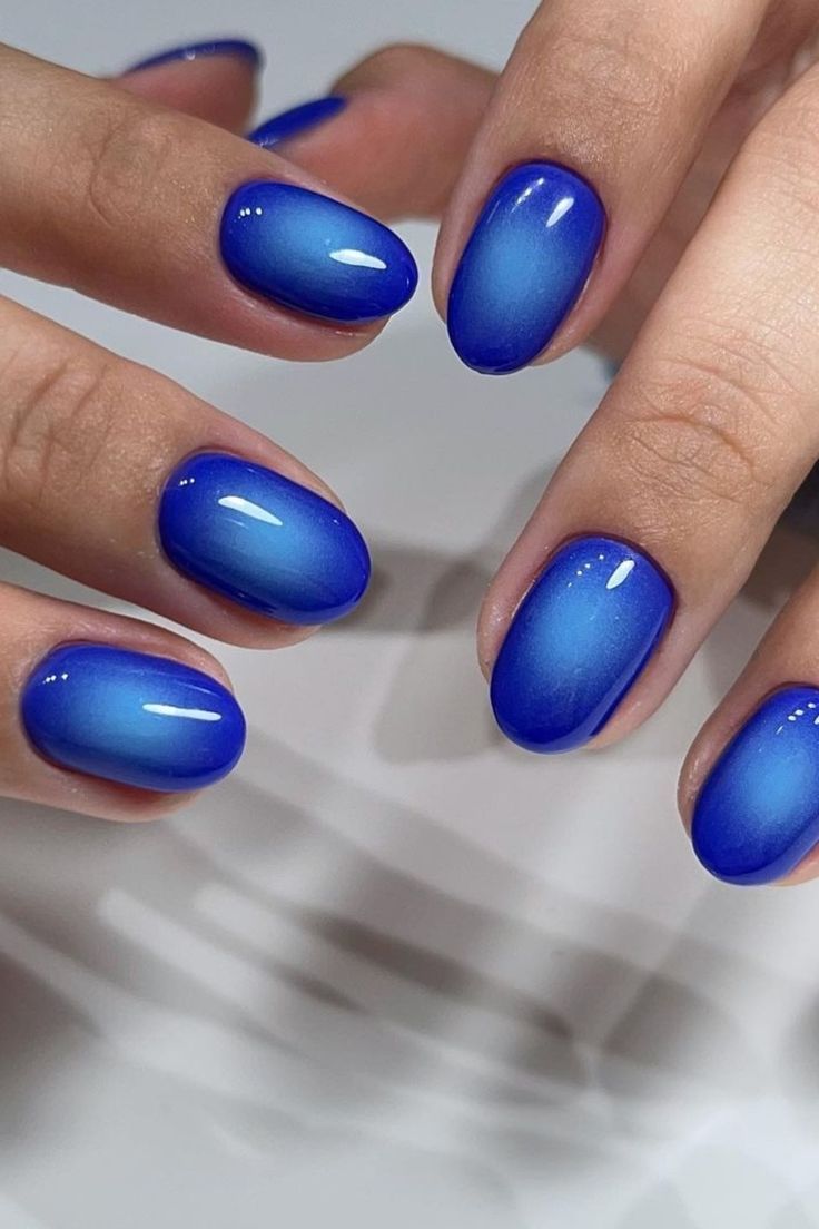 Chic Ombre Blue Nail Design: Striking Gradient with Sophisticated Glossy Finish.