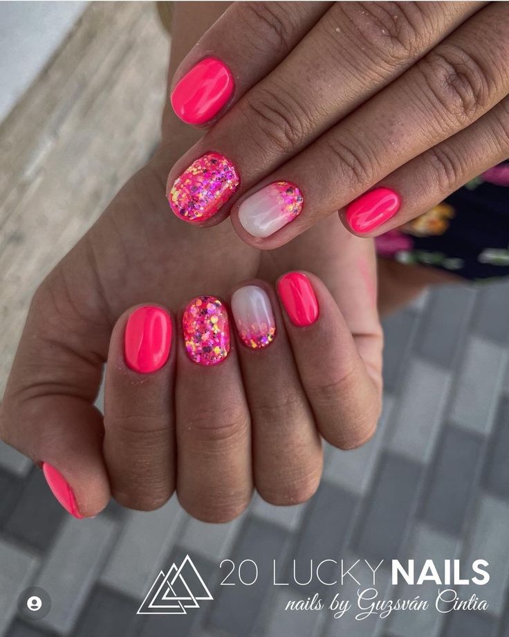 Vibrant Pink Nail Design with Playful Glitter Accents for a Fun Look.