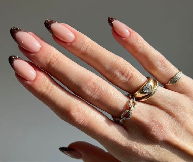 Sophisticated Nude and Dark Brown French Tip Nails with Shimmer, Perfect for Any Occasion.