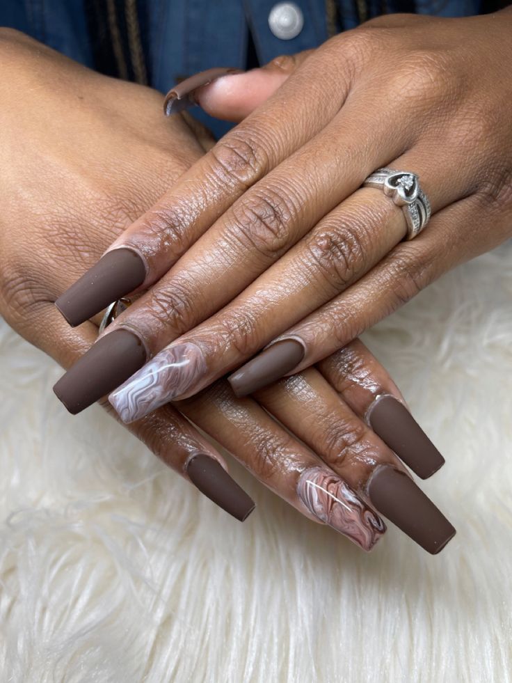 Sophisticated Matte Brown Nails with Artistic Marble Design.