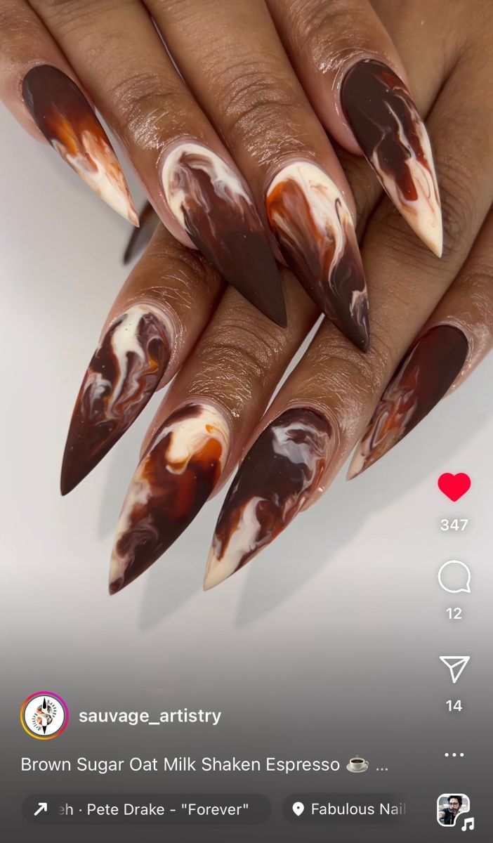 Elegant Triangular Almond Nails with Rich Brown and Cream Marble Design.