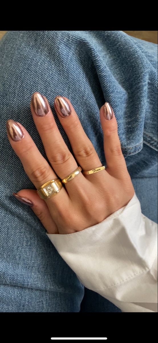 Sleek Metallic Nail Design with Gold Accents and Casual Denim Backdrop