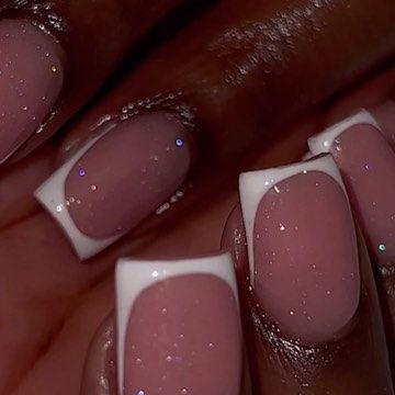 Elegant Nude and White Nail Design with Glossy Finish and Glitter Accents