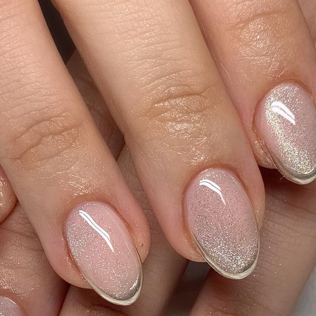 Sophisticated Nude Ombre Nails with Sparkly Finish and Delicate White Tips.