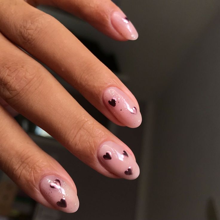 Romantic Soft Pink Nail Design with Heart Motifs and Glossy-Matte Finish