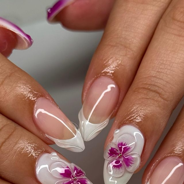 Sophisticated Nail Design: Delicate White Tips with Floral Orchid Accents.