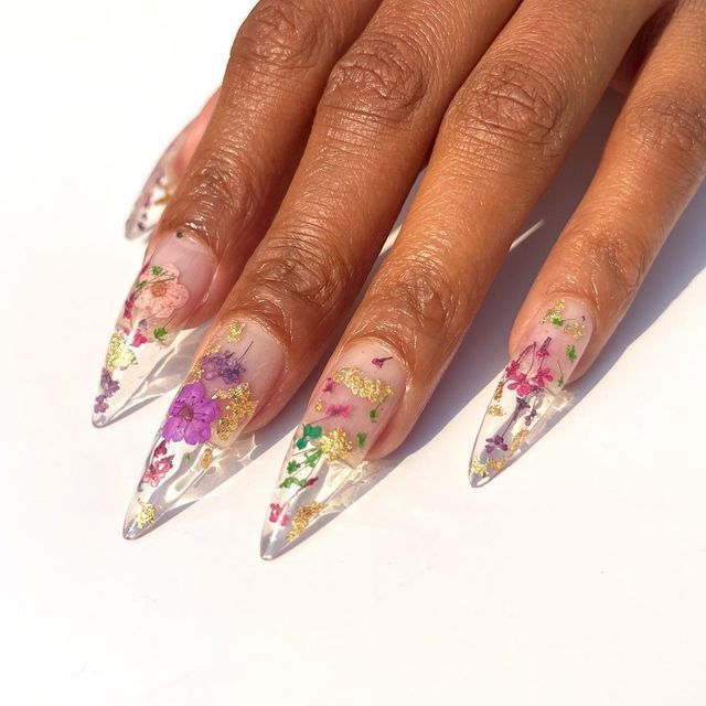 Elegant Floral Nail Design with Almond-Shaped Tips and Colorful Dried Flowers.