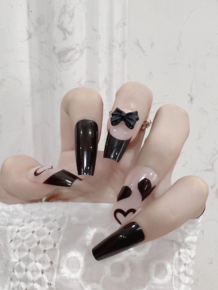 Chic Acrylic Nails: Glossy Black and Nude Elegance with Whimsical Details