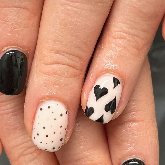 Elegant Black and White Chic Nail Design with Whimsical Patterns