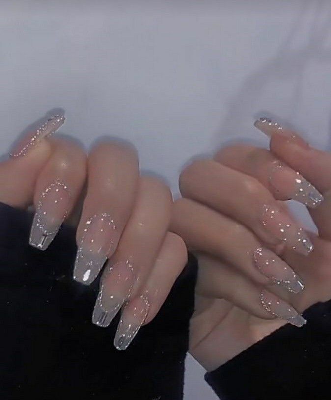 Sophisticated Nail Design: Clear and Silver Elegance with Sparkling Tips.