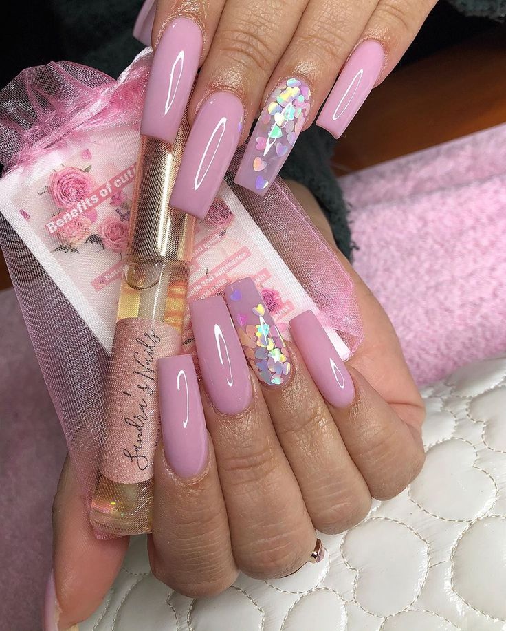 Elegant Soft Pink Manicure with Glossy Finish and Playful Sequin Accent Nail.