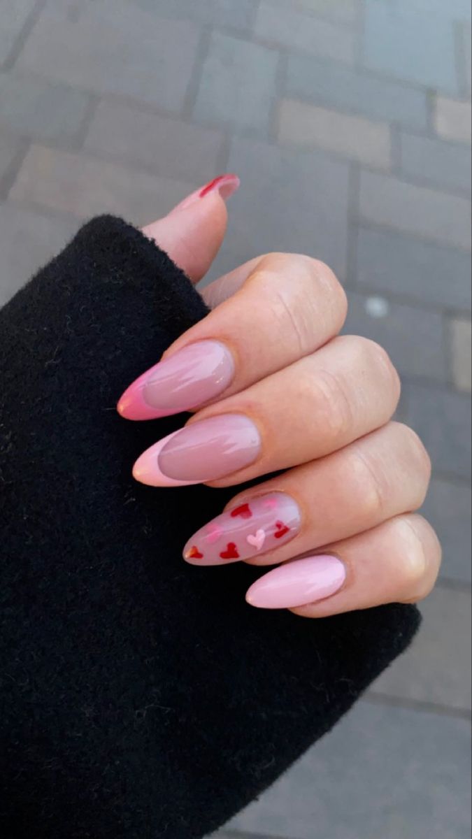 Sophisticated Ombre Pink Nail Design with Whimsical Red Heart Accents.