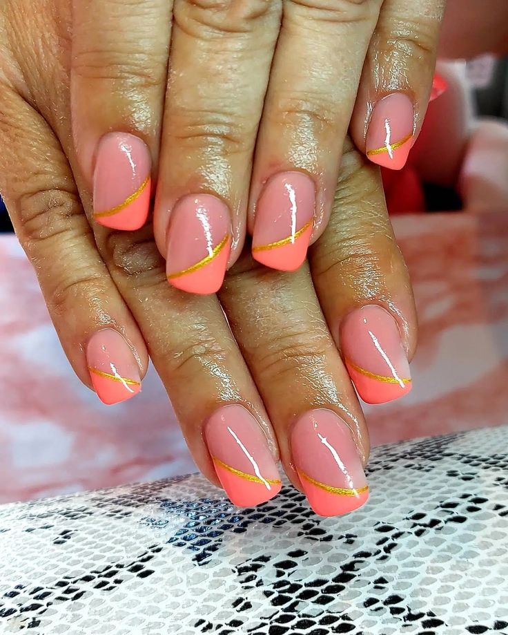 Elegant Nail Design: Soft Pink and Vibrant Coral with Gold Accents for a Chic Touch