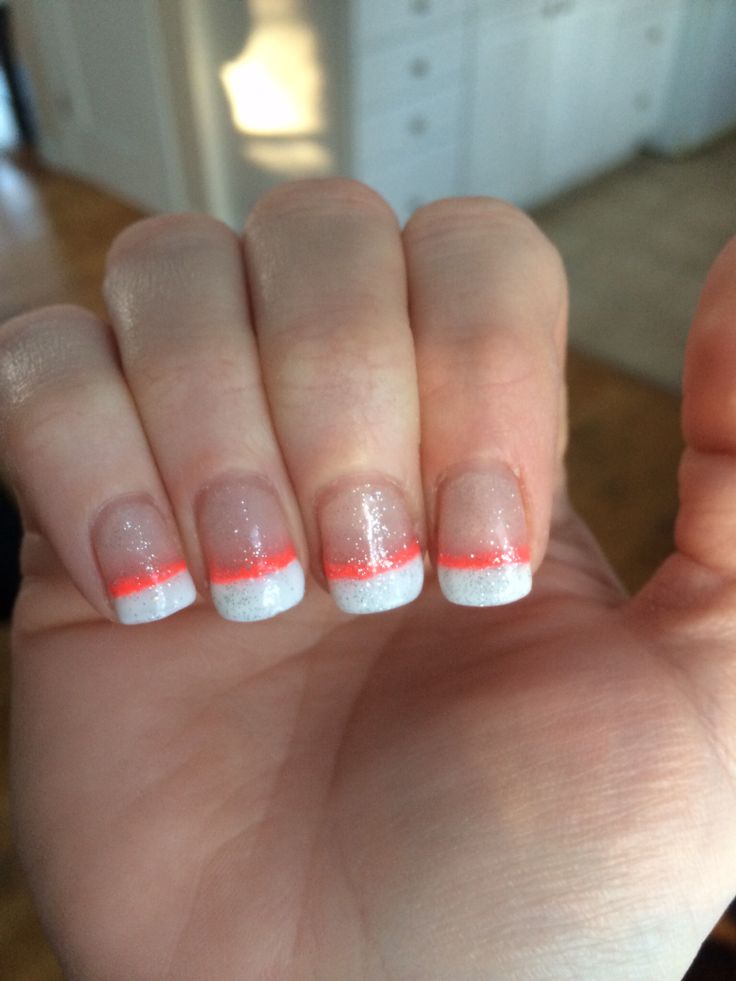 Chic Nail Design: Sparkling White and Clear Polish with Vibrant Neon Orange Tips