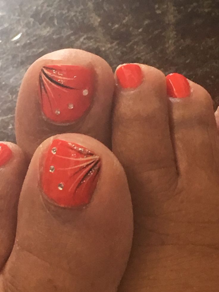 Glamorous Coral Pedicure with Intricate Designs and Rhinestones