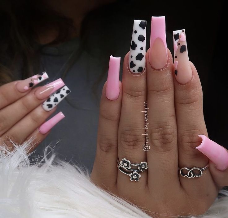 Chic Long Nails: Playful Pink Base with Trendy Cow Print Accents.