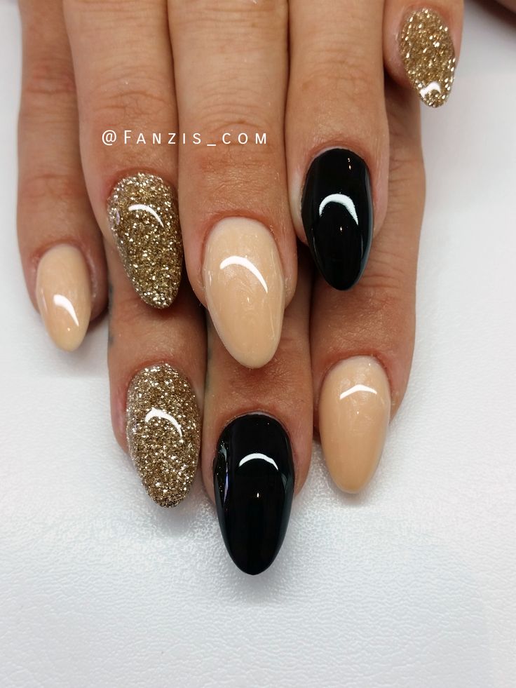 Elegant Almond-Shaped Nail Design: Glossy Black, Shimmering Gold Glitter, and Nude Polish Combination.