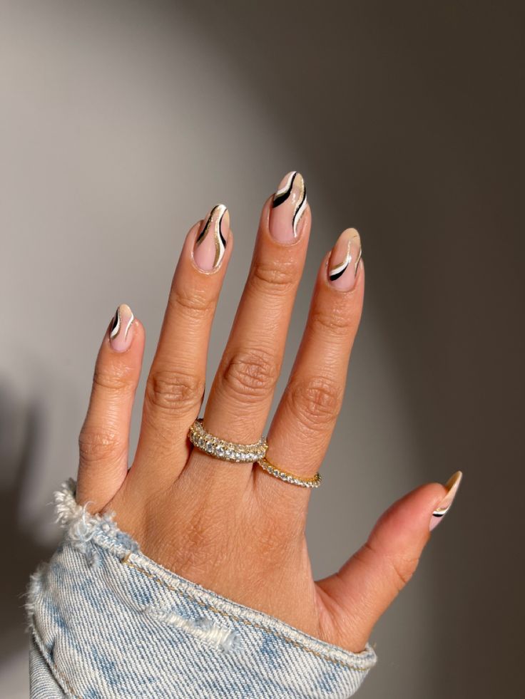 Chic Nude and Black Nail Design with Modern Wavy Accents.