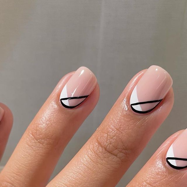 Chic Modern Geometric Nail Design with Soft Pink Base and Elegant Black and White Contrast