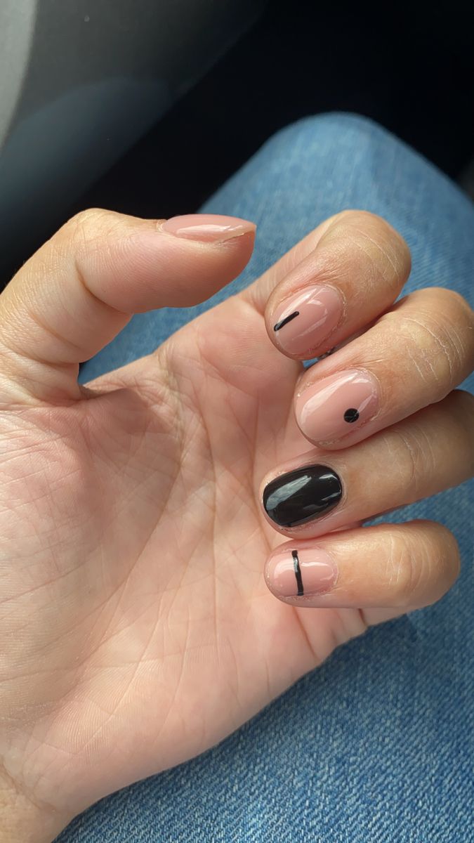 Elegant Nude and Black Nail Design with Minimalist Accents.