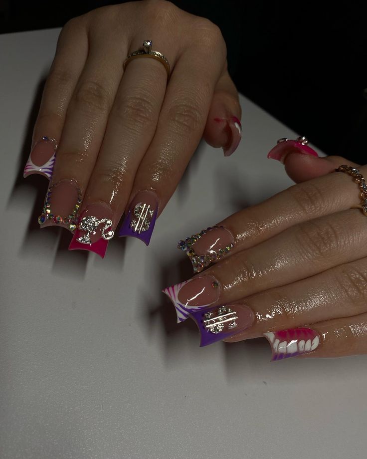 Vibrant Geometric Nail Design with Pink, Purple, and Glossy Finishes Enhanced by Gems and Metallic Accents