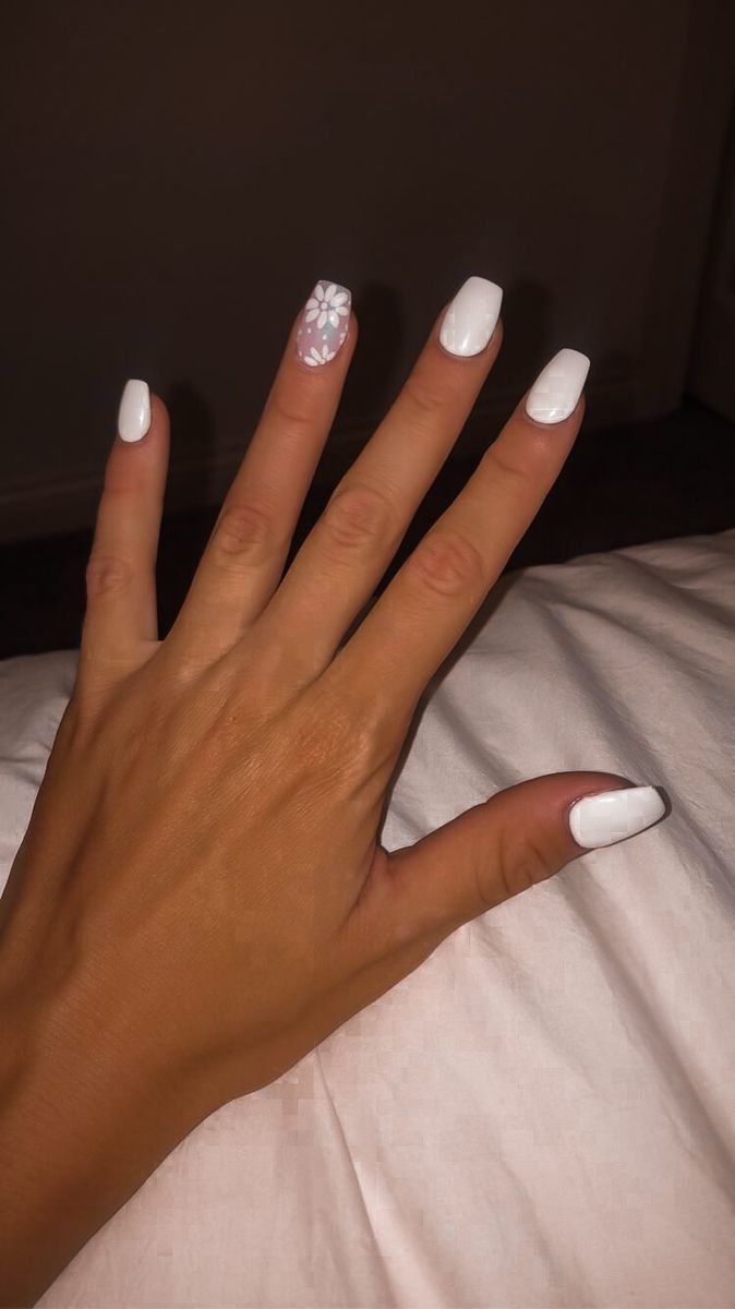 Chic Minimalist White Nail Design with Playful Floral Accent.