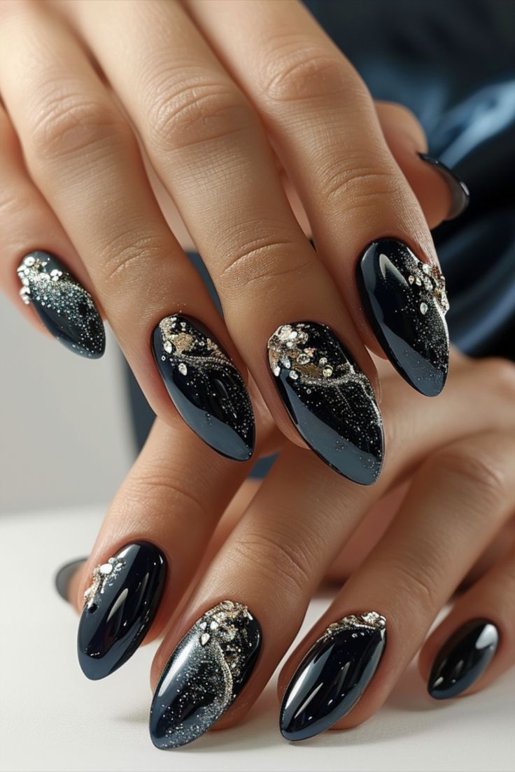 Glamorous Almond-Shaped Nails: Glossy Black Finish with Elegant Gold Accents and Intricate Designs