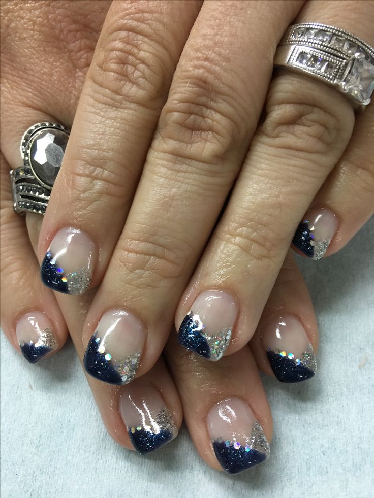 Chic French Tip Nail Design with Navy Blue and Silver Glitter for Glamorous Sophistication.