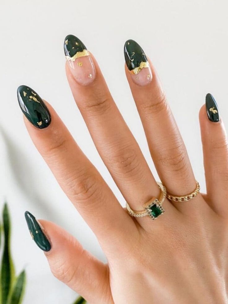 Sophisticated Deep Green Almond Nail Design with Gold Accents and Unique Transparency.