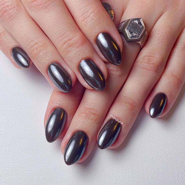 Elegant Dark Nail Design: Sophisticated Glossy Finish with Chic Oval Shape.