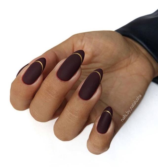 Sophisticated Maroon Matte Almond Nails with Subtle Gold Accents.