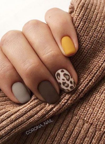 Chic Nail Design with Muted and Bold Colors Featuring Matte Finishes and Trendy Leopard Print Accent.