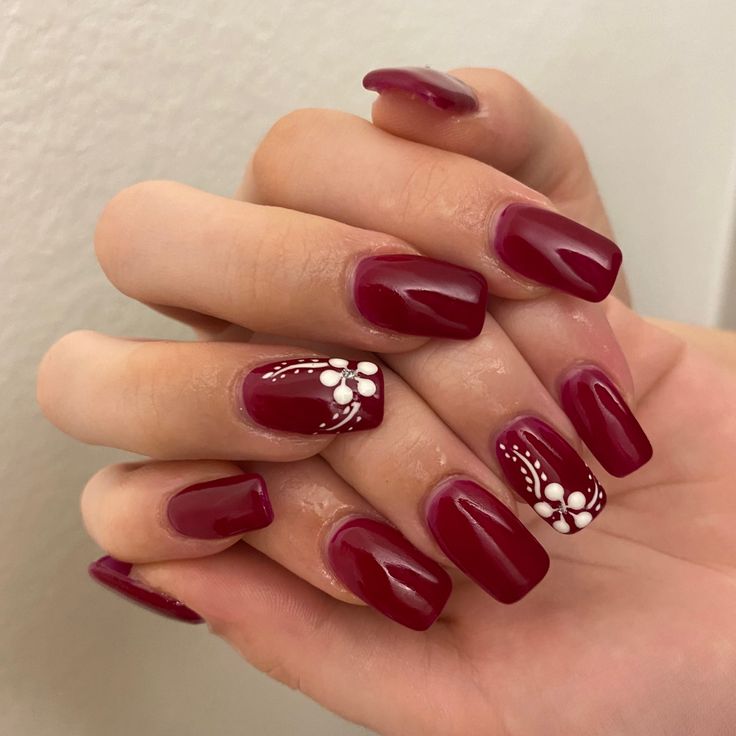 Elegant Red Manicure: Glossy and Matte Finish with Intricate Floral Designs on Polished Square Nails