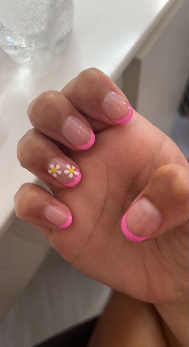 Vibrant Pink Tip Nail Design with Floral Accent: A Cheerful Blend of Color and Elegance.