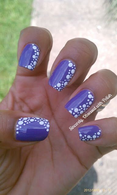 Playful Purple Nail Design with Unique White Polka Dots for a Colorful Touch.