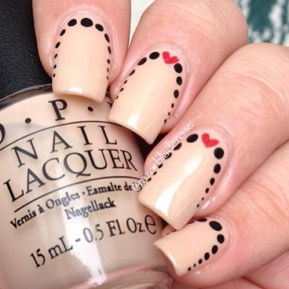 Charming Playful Nail Design: Nude Base with Black Dots and Red Hearts