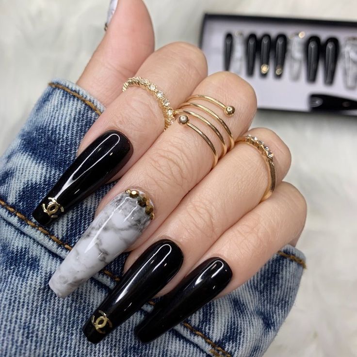 Chic Black Marble Nail Design with Gold Accents and Denim Backdrop