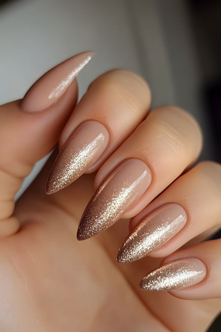 Chic Gradient Stiletto Nails: Soft Nude Base with Shimmering Gold Tips