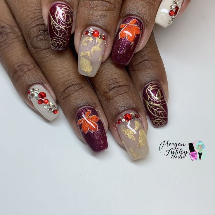 Sophisticated Nail Design: Burgundy, Beige, Gold Leaf, and Floral Accents