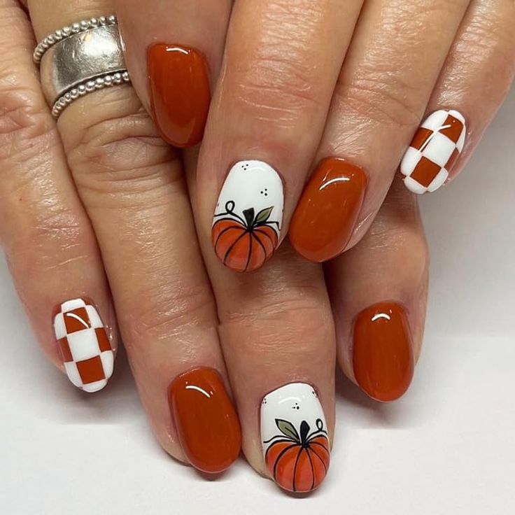 Charming Autumn Nail Design: Rich Oranges with Playful Pumpkin Accents