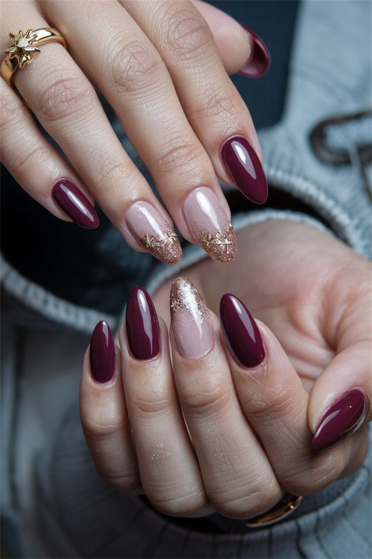 Chic Almond-Shaped Nail Design in Deep Burgundy and Soft Nude with Glitter Accents.