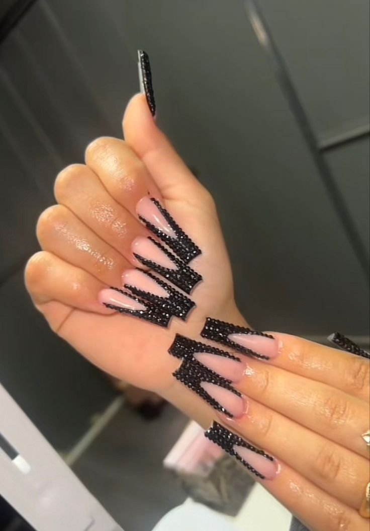 Edgy Angular Nail Design with Bold Black Patterns and Futuristic Flair