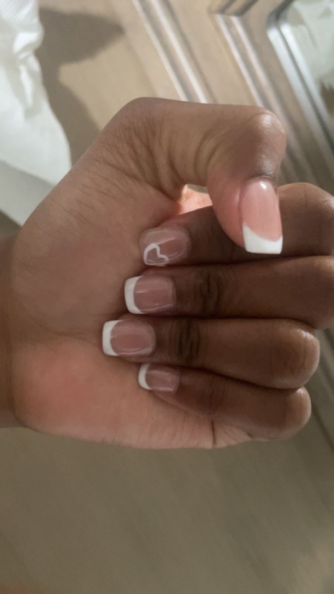 Chic French Tip Nail Design with Delicate Heart Accent