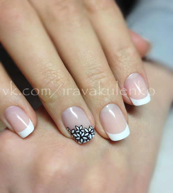 Sophisticated French Tip Nail Design with Elegant Black Floral Accent.